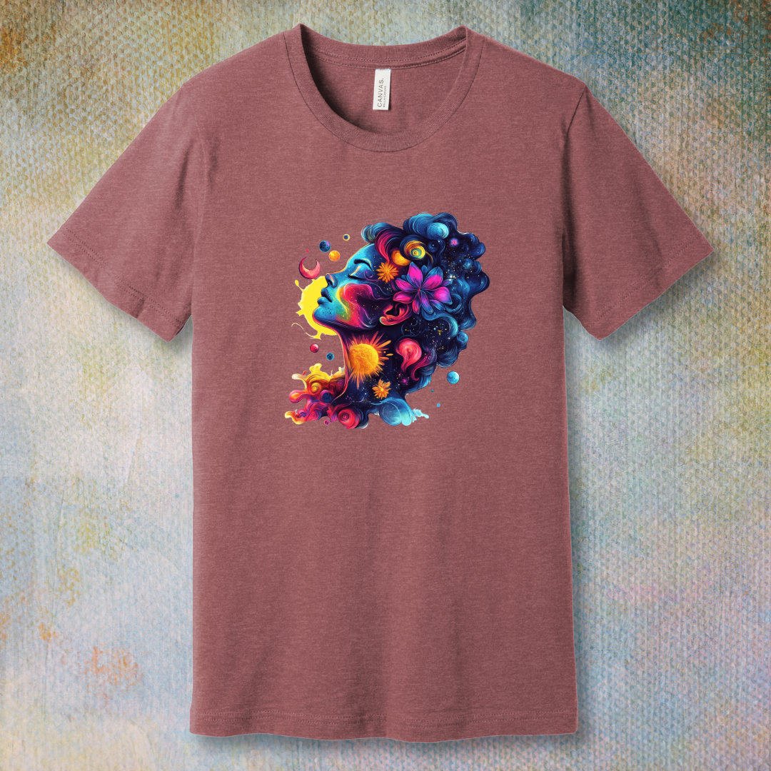 Colorful cosmic art T-shirt of a woman's face blending with stars, planets, and swirling energy—representing dreams, imagination, and universal beauty.