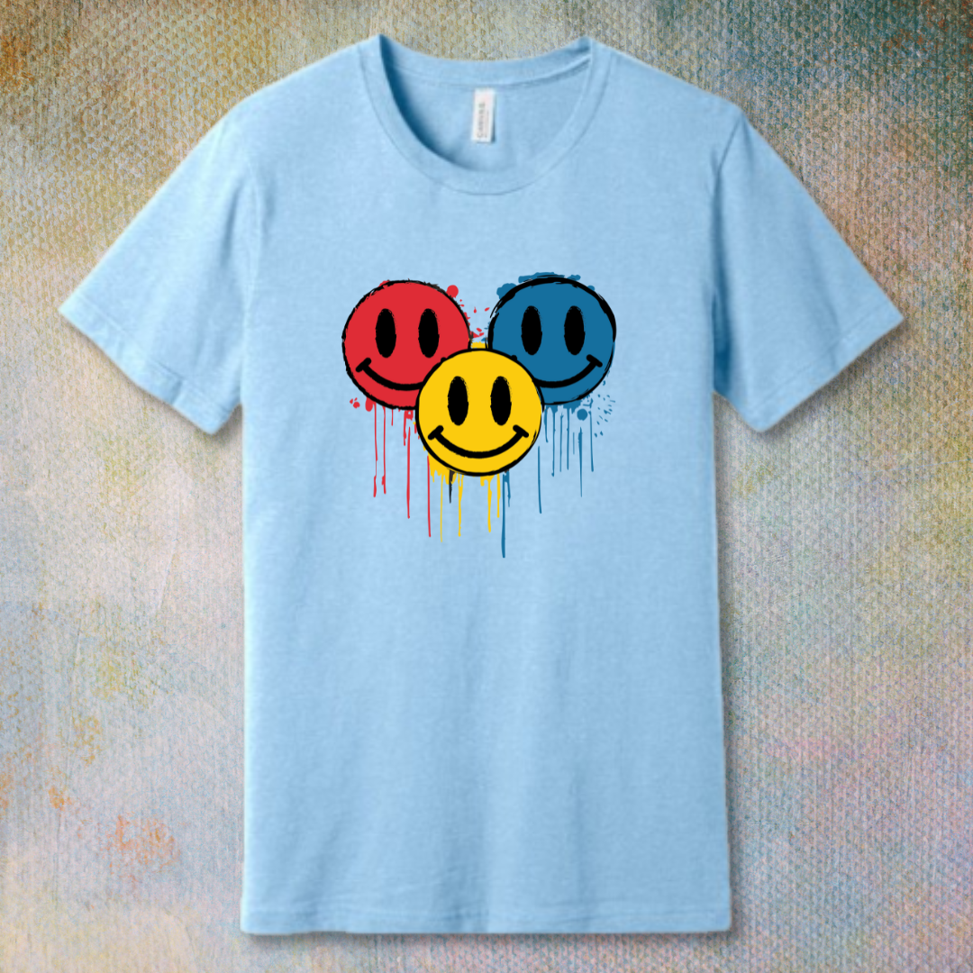 Drip Smile t-shirt — red, yellow, and blue smiley faces dripping paint on baby blue tee