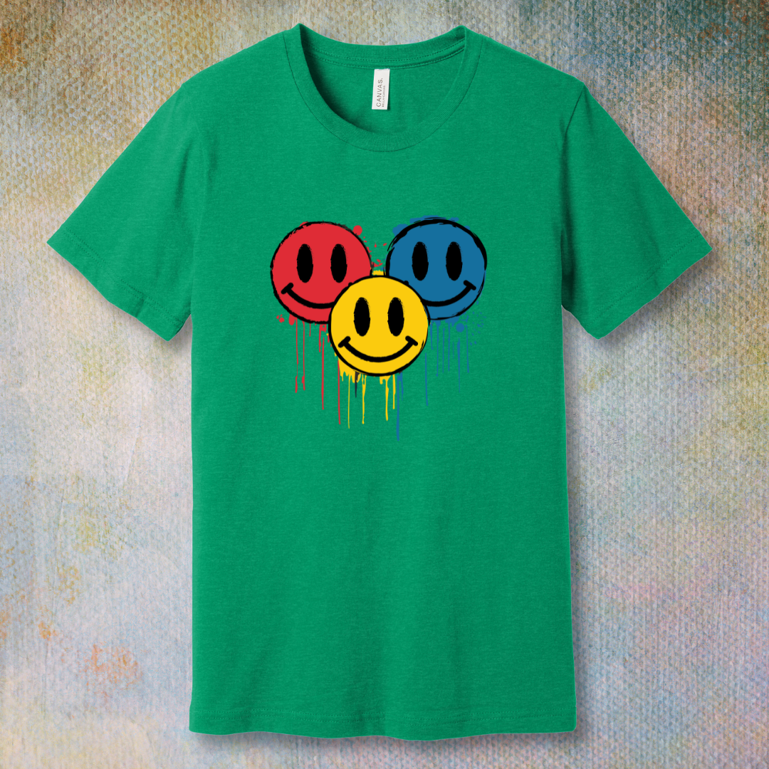Drip Smile t-shirt — red, yellow, and blue smiley faces dripping paint on kelly tee