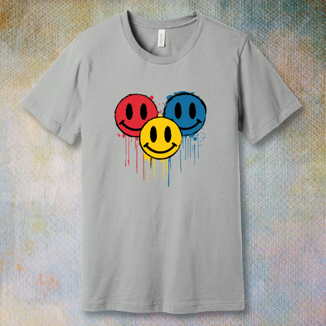 Drip Smile t-shirt — red, yellow, and blue smiley faces dripping paint on silver tee
