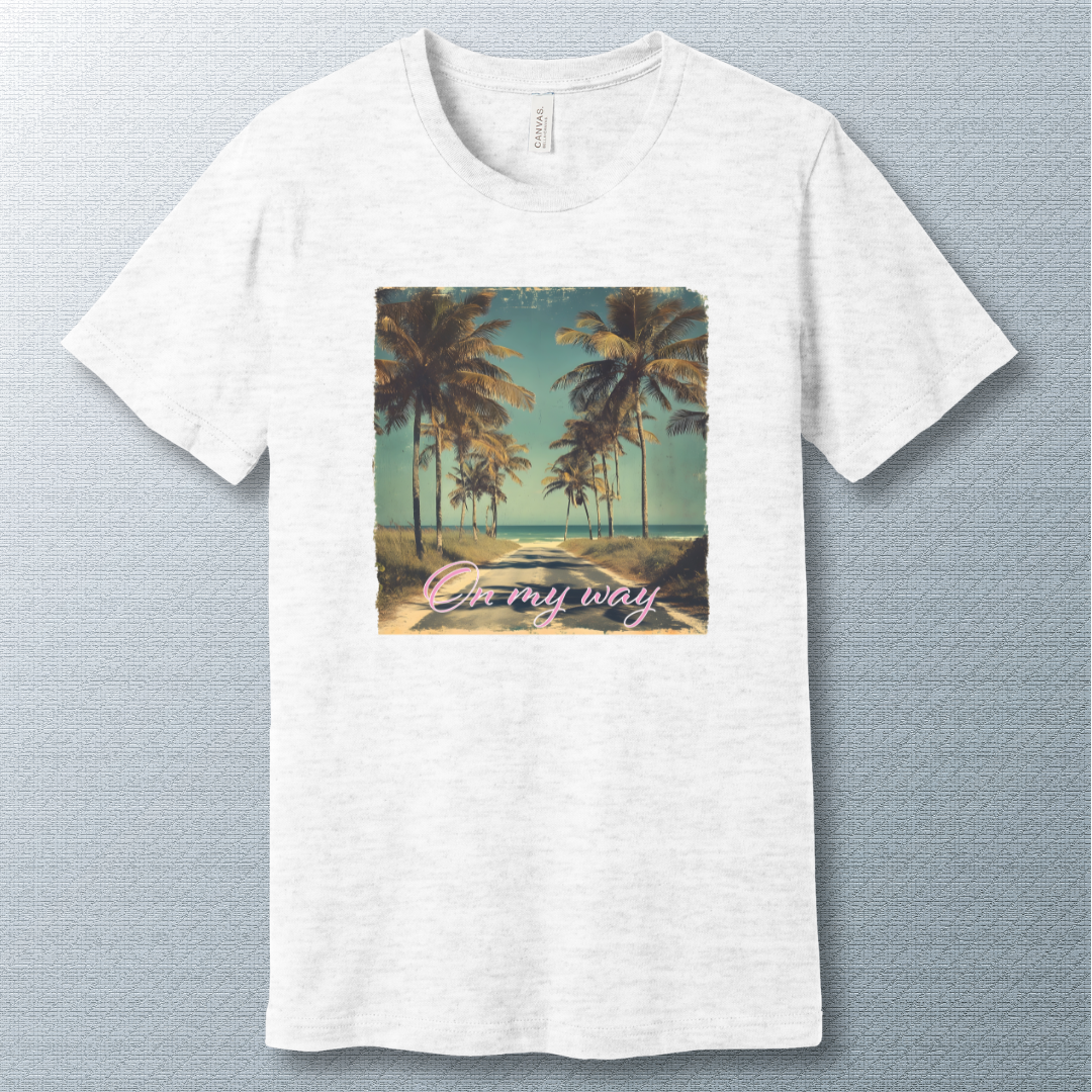 Tropical beach road lined with palm trees under a clear sky, with the phrase "On my way" in pink cursive script — vintage postcard-style design.