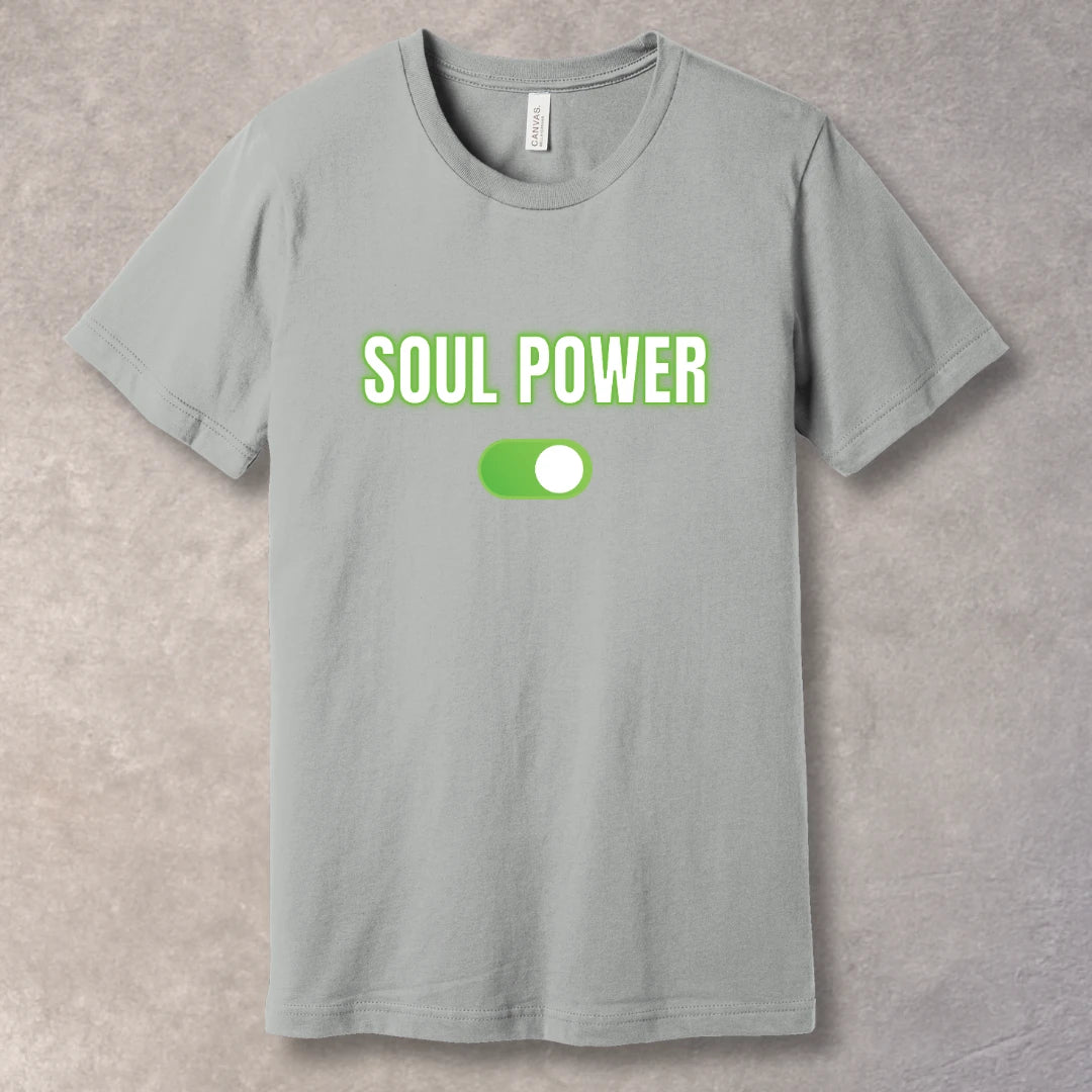 White text “SOUL POWER” with neon green glow above a bright green ON switch on a silver T-shirt – motivational graphic tee design.
