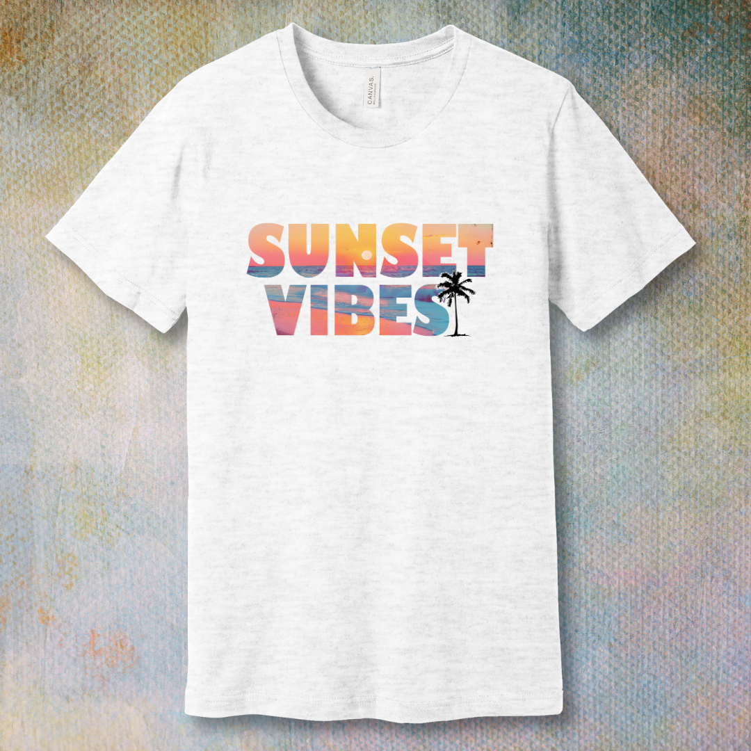 Ash T-shirt with a colorful 'Sunset Vibes' design featuring a stylized sun setting over waves – soft spiritual energy and summer vibes combined.