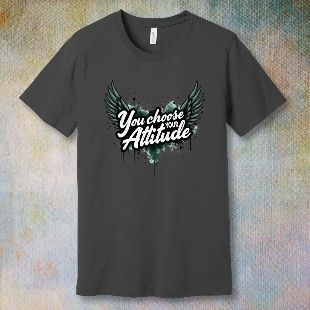 Asphalt motivational T-shirt with “You Choose Your Attitude” text and black wings graphic over ink-splatter background
