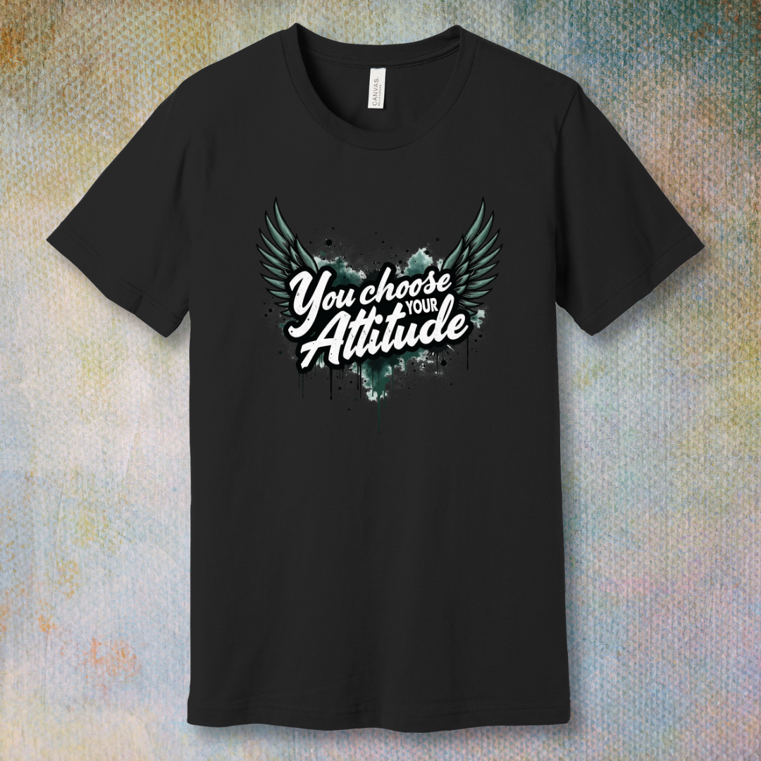 Black motivational T-shirt with “You Choose Your Attitude” text and black wings graphic over ink-splatter background