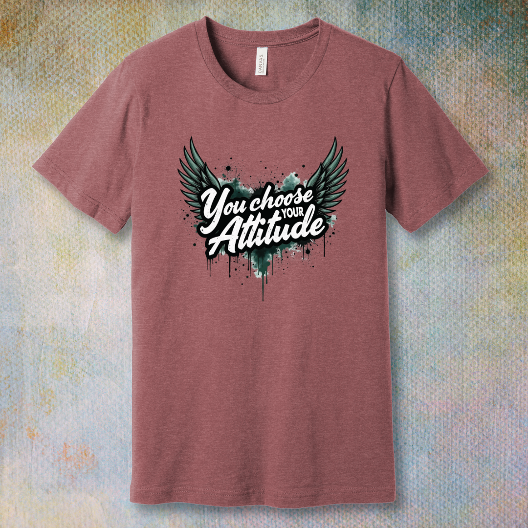 Heather Mauve motivational T-shirt with “You Choose Your Attitude” text and black wings graphic over ink-splatter background