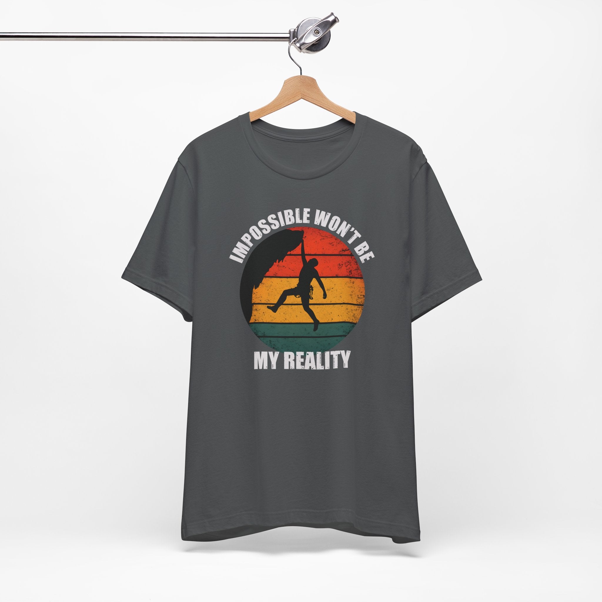 Asphalt T-shirt with rock climber silhouette over retro sunset with text “Impossible Won’t Be My Reality”