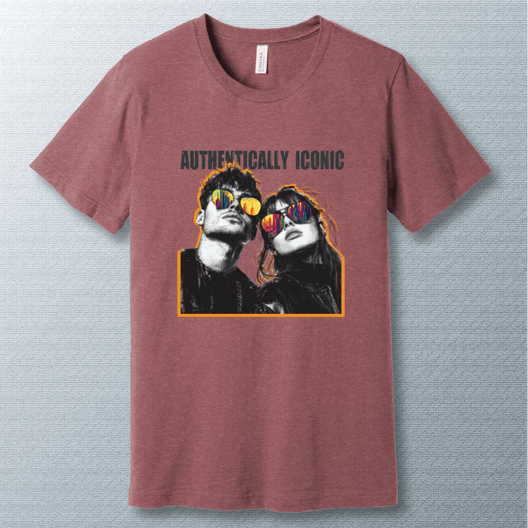 Pop art style design of a confident man and woman wearing sunglasses with colorful city reflections, under the bold text "AUTHENTICALLY ICONIC" – T-shirt.