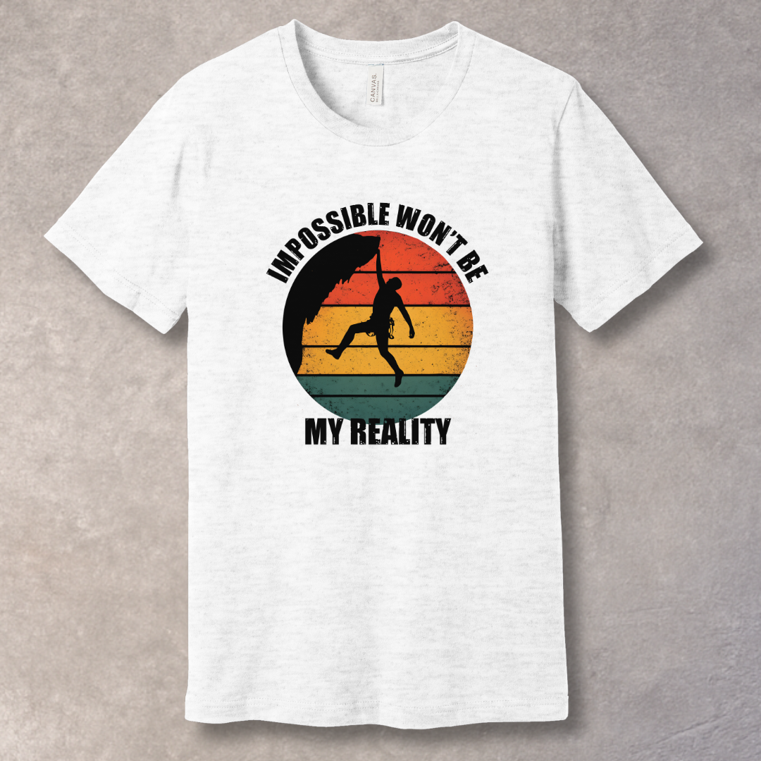 Ash T-shirt with rock climber silhouette over retro sunset with text “Impossible Won’t Be My Reality”