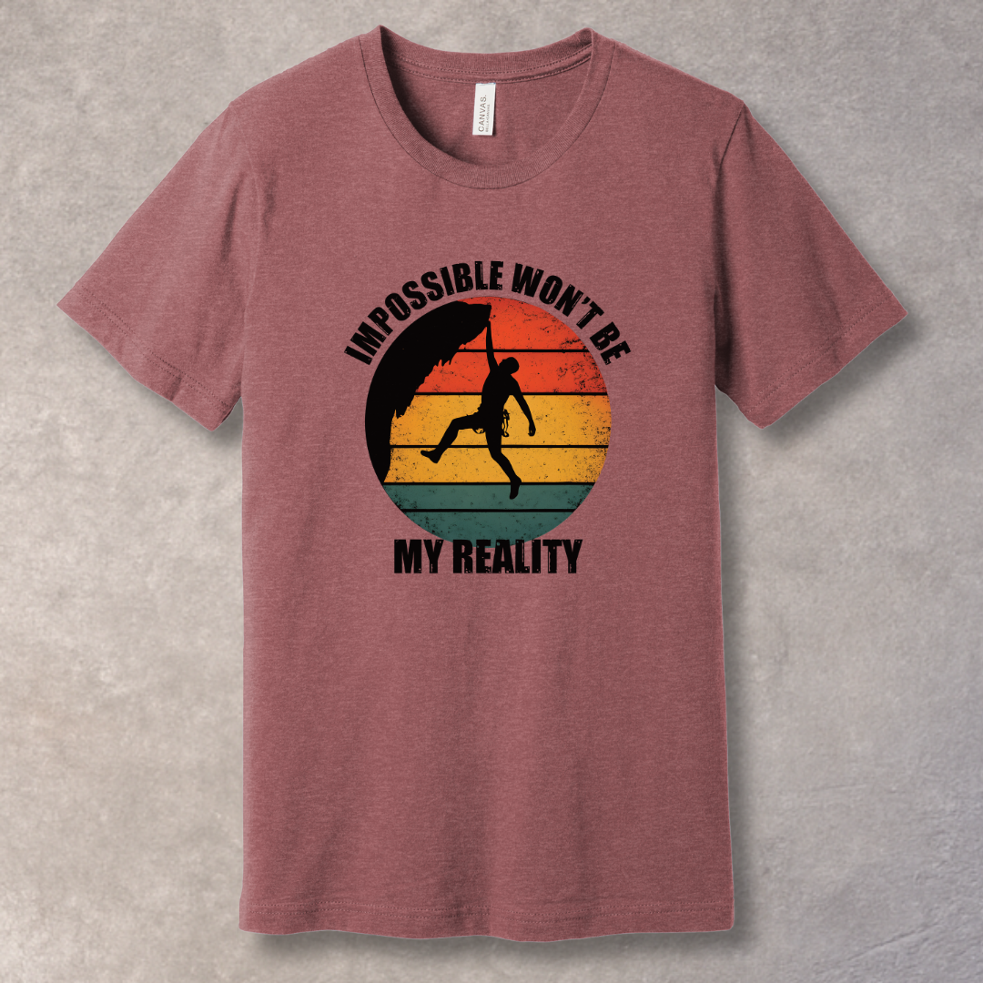 Heather Mauve T-shirt with rock climber silhouette over retro sunset with text “Impossible Won’t Be My Reality”
