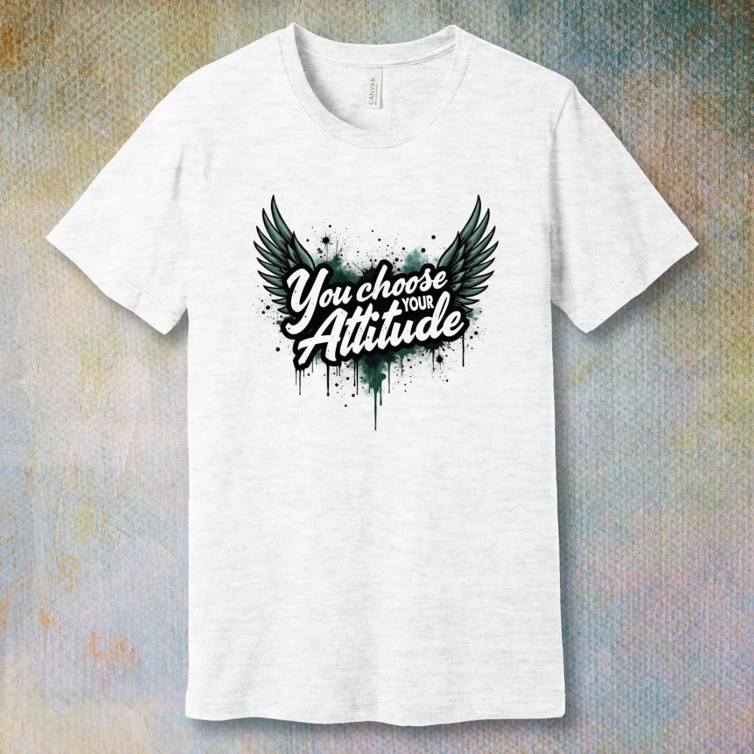 Ash motivational T-shirt with “You Choose Your Attitude” text and black wings graphic over ink-splatter background